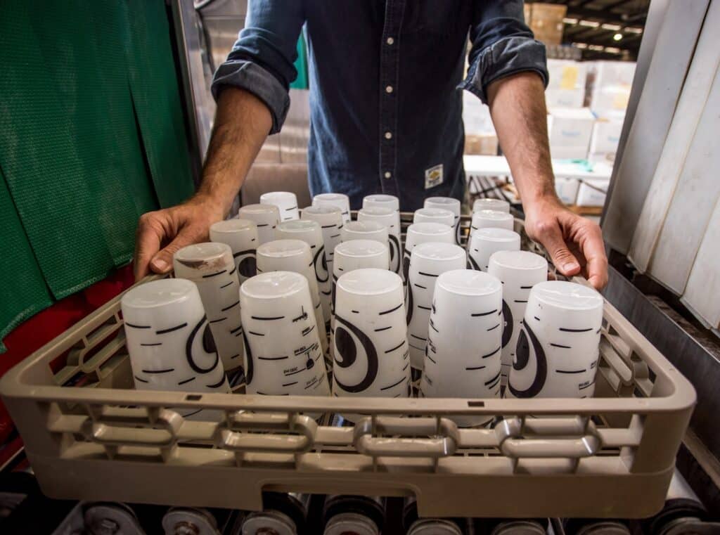 white ceramic mugs on white tray on dshwasher